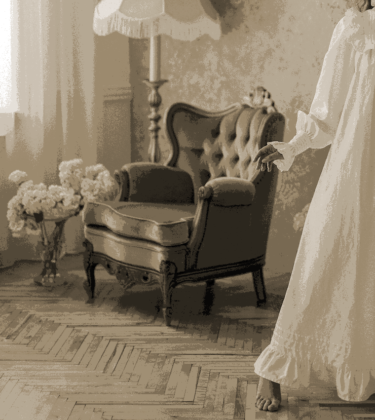 A picture of a chair with the outline of a woman in a night gown at the edge of the photo